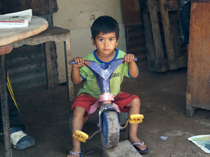 A young boy on a tricycle