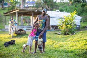 A man holding his daughters on Vanauatu