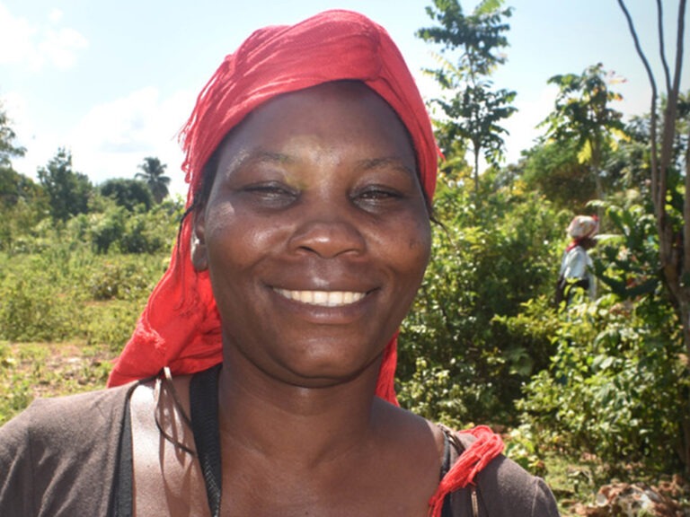 Woman wearing a red hair scarf smiling