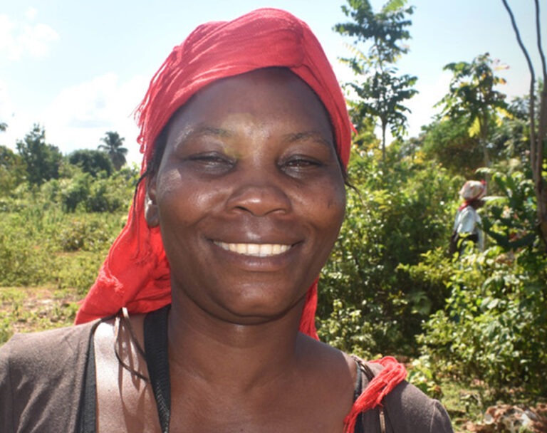 Woman wearing a red hair scarf smiling