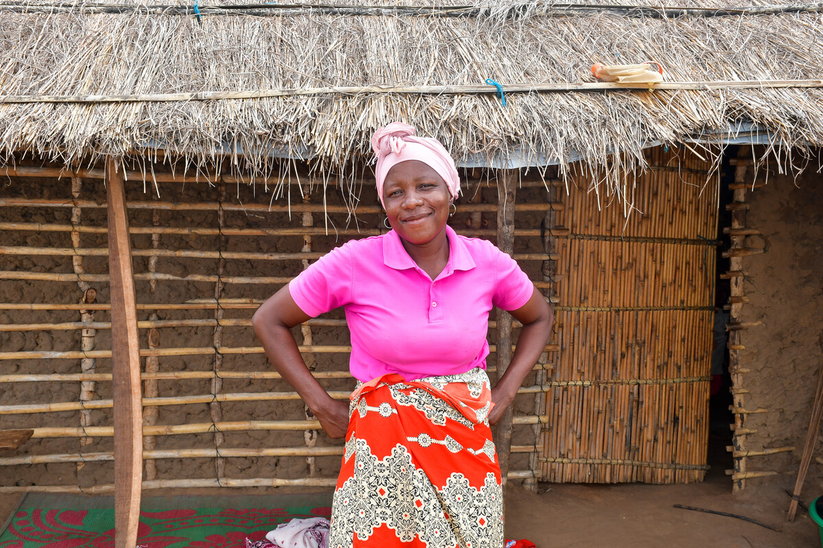 Woman standing in front of her shelter in Mozambique