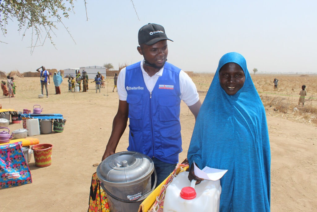 Man carrying aid next to a woman in Cameroon