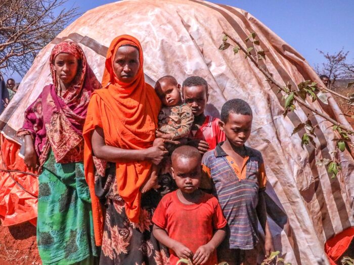 Woman and 5 children stood in from of a shelter in Ethiopia