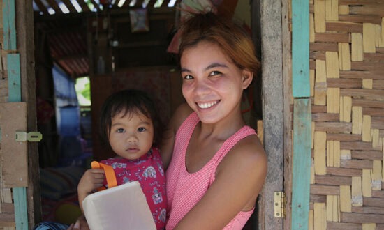 Woman holding child and a solar light