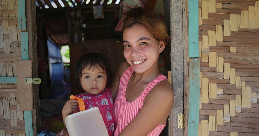 Woman holding child and a solar light